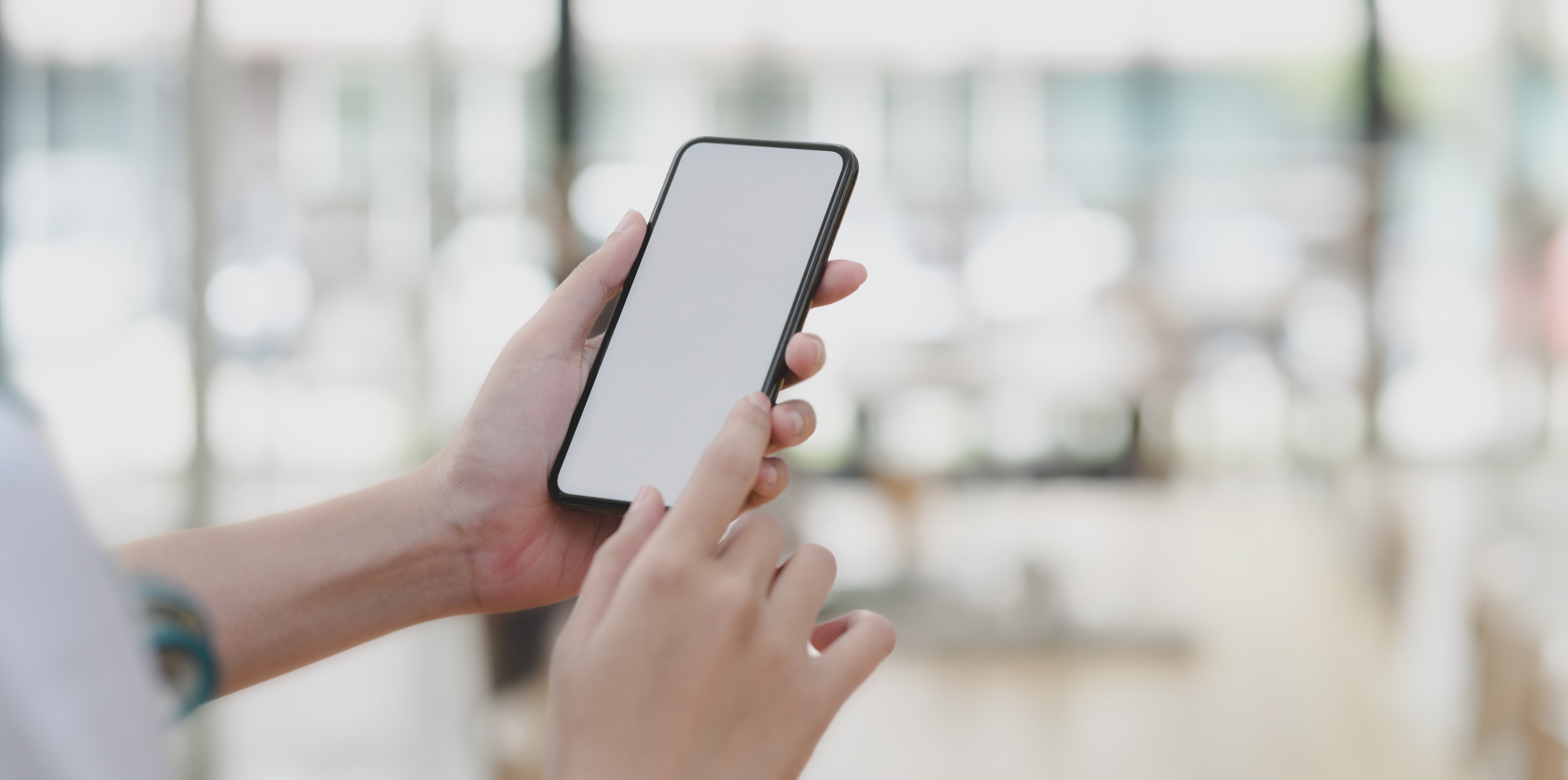 Cropped shot of young female professional doctor using her smartphone